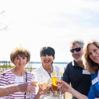 President Mantella with group of four other event attendees toasting at event